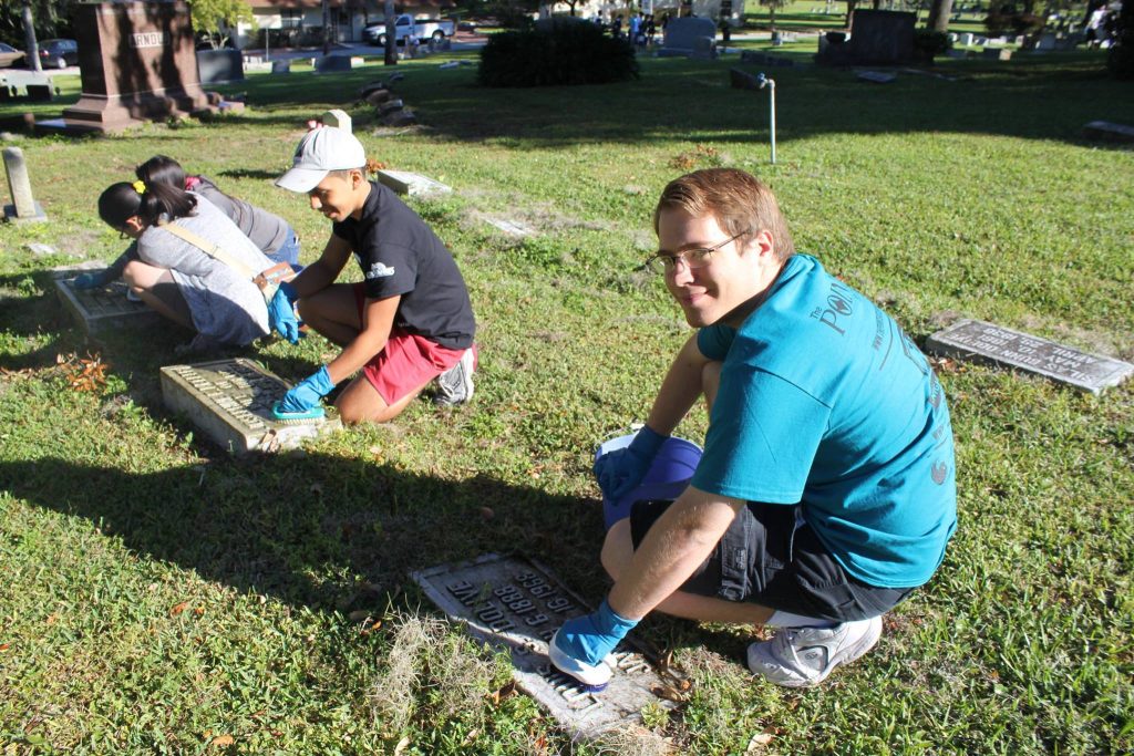 Cleaning headstones at Greenwood Cemetery