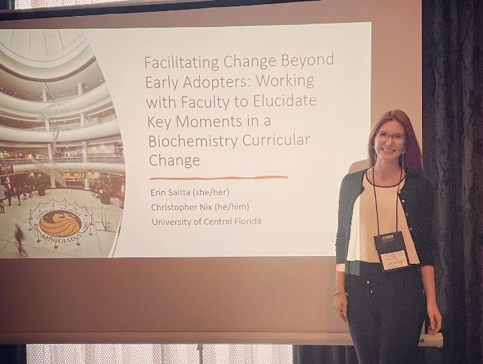 A woman standing in front of a presentation.