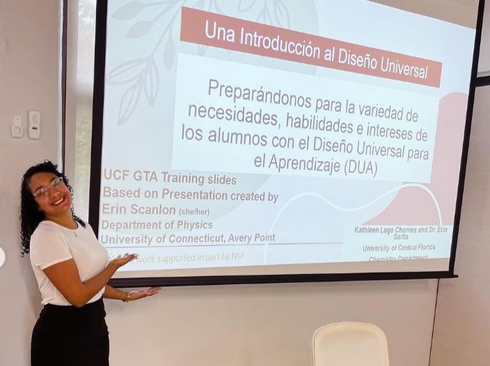 A woman giving a presentation in front of a screen.