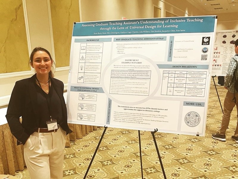 A woman standing in front of a poster at a conference.