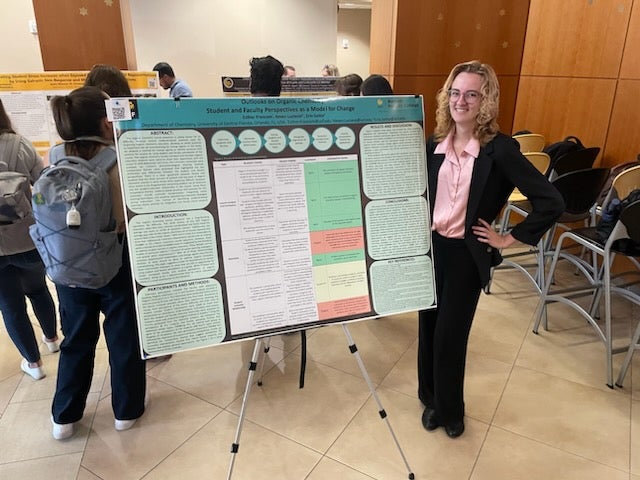 Esther presents a poster at the UCF Chemistry Seminar poster session.