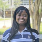 Emanuella in a blue striped shirt.