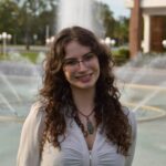 Victoria in a white blouse.